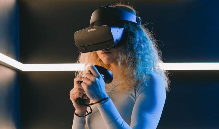 A woman fully immersed in a game at a VR arcade.